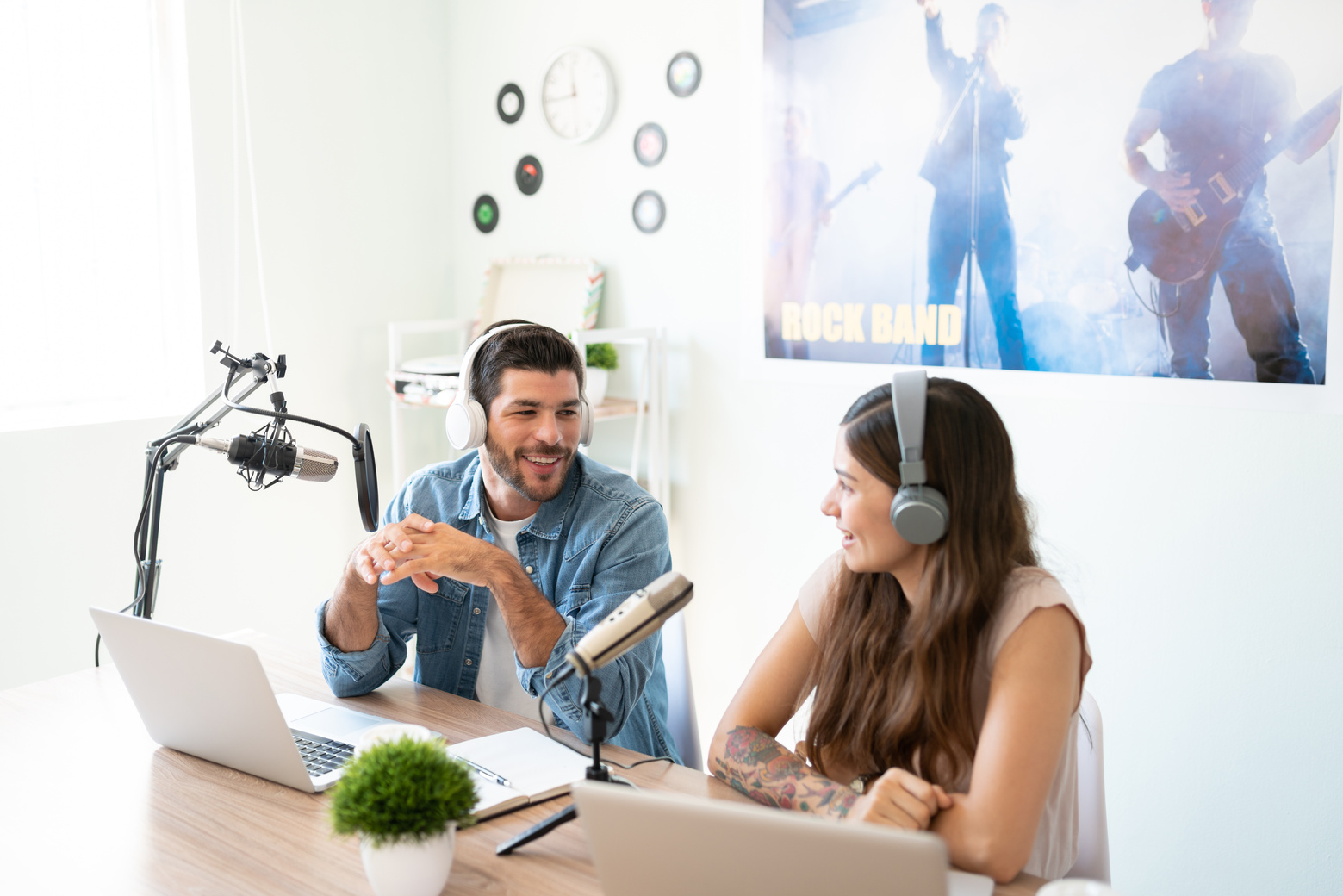 Cohosts recording a live podcast
